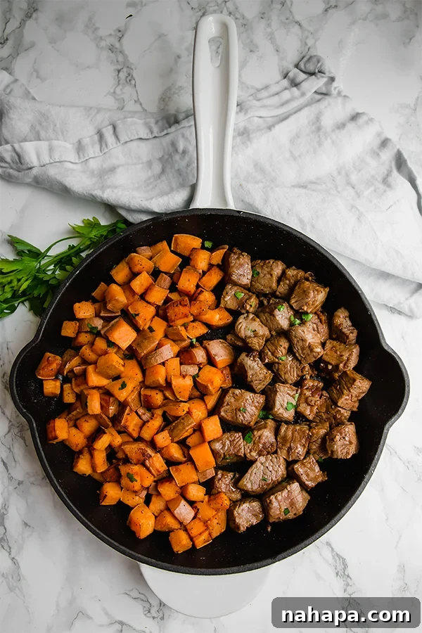 One-Pan Steak and Sweet Potato dish garnished with fresh parsley