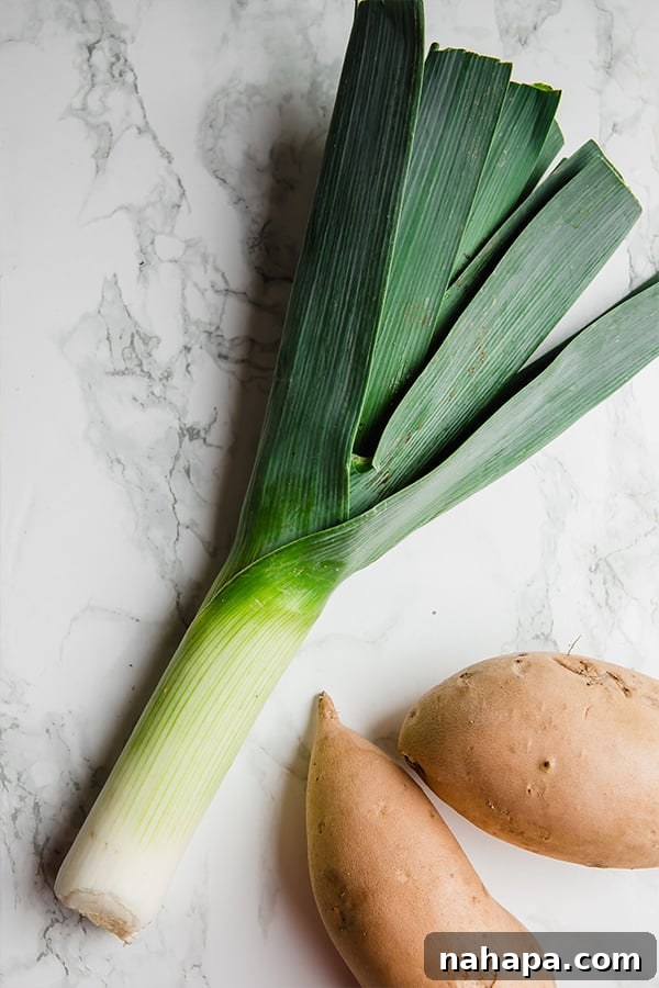 A selection of fresh leeks and white sweet potatoes, key ingredients for a wholesome and comforting soup.