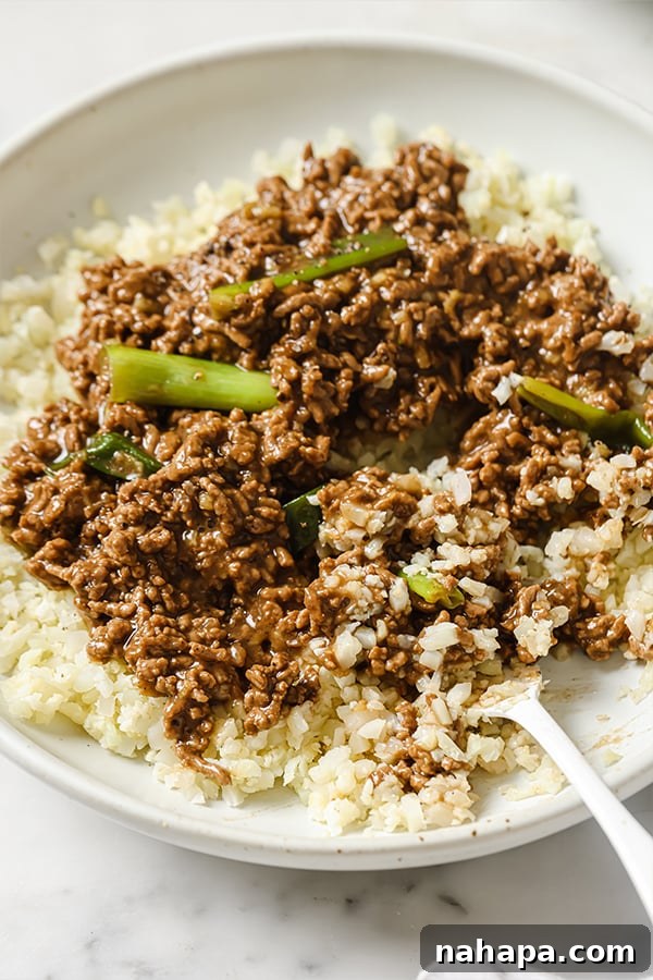 Plated Mongolian Ground Beef with cauliflower rice and roasted bok choy.
