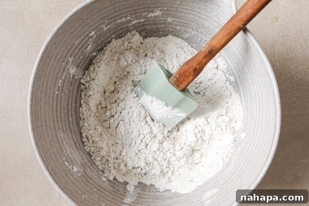 Dry ingredients in a bowl with a spatula