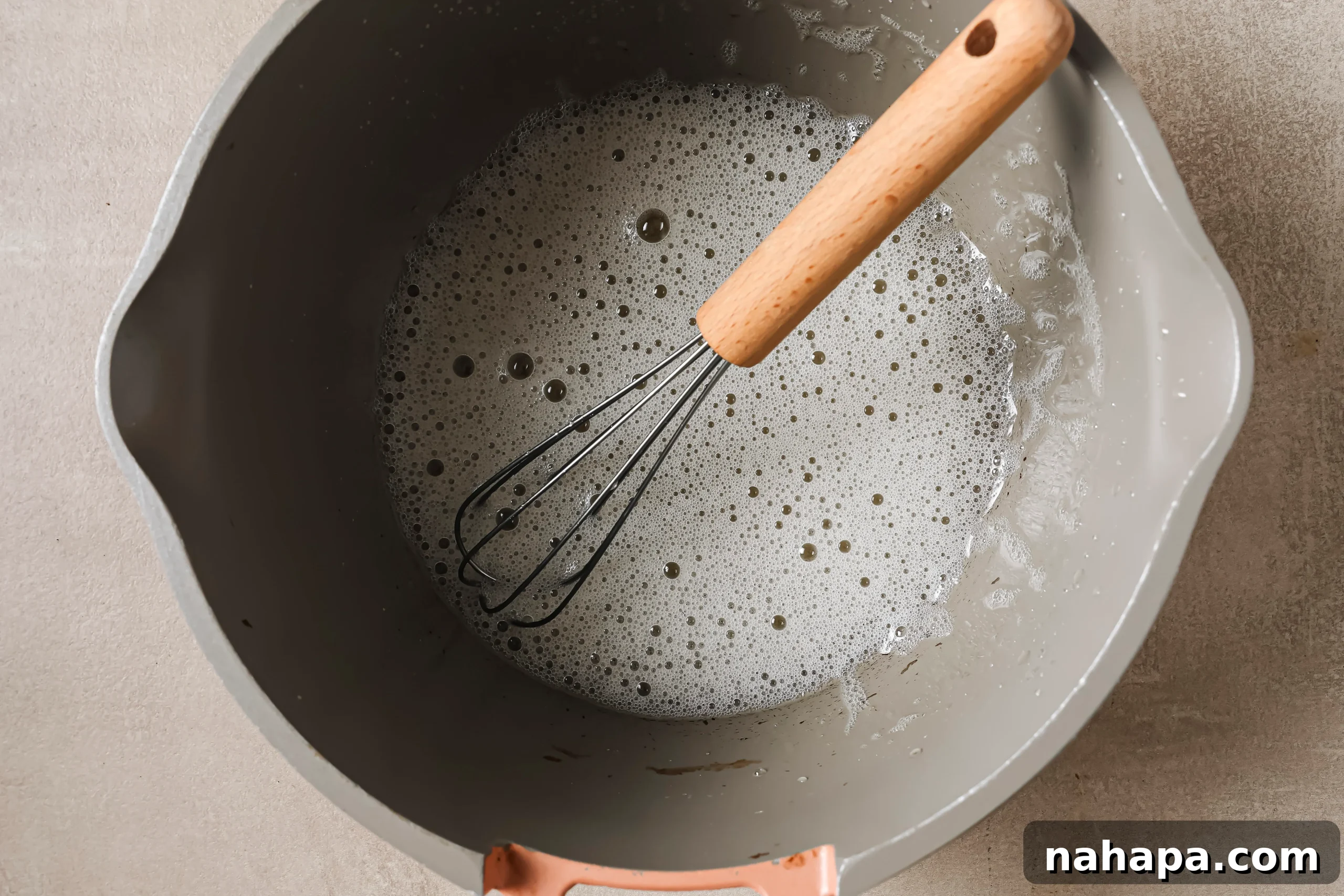 Gelatin egg in a pot after the mixture has been heated and frothed.
