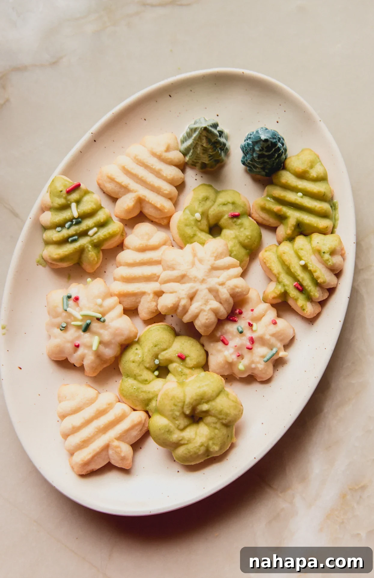 Beautifully decorated spritz cookies arranged on a festive holiday plate, ready for serving.