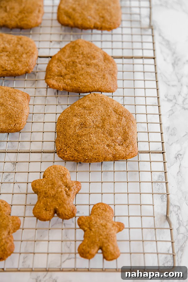 Freshly baked gingerbread house pieces cooling on a rack