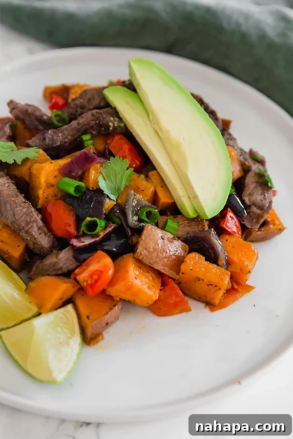 Breakfast Taco Hash on a plate with avocado and lime