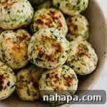 Mediterranean Harvest Chicken and Veggie Meatballs 5 Mediterranean Chicken Meatballs recipe image, showing a small bowl of cooked meatballs with herbs.