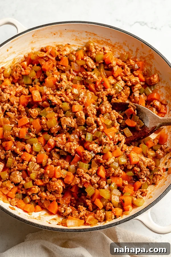 Ultimate Turkey Shepherds Bake 3 The savory turkey and vegetable filling cooking in an oven-safe skillet.