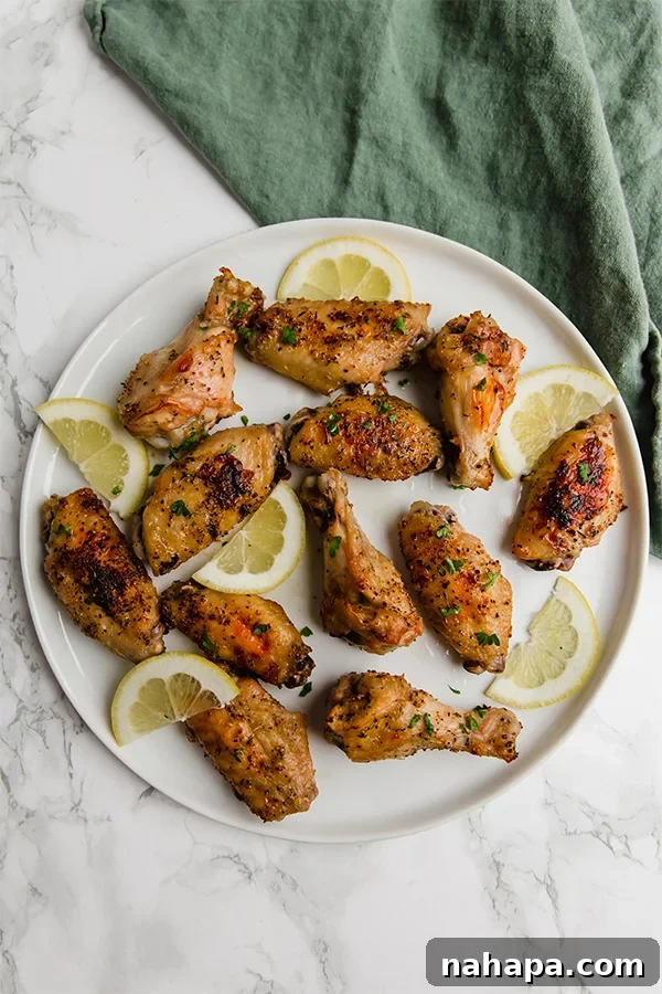 Zesty Lemon Pepper Wings 3 Close-up of baked Lemon Pepper Chicken Wings, showcasing their golden, crispy skin.
