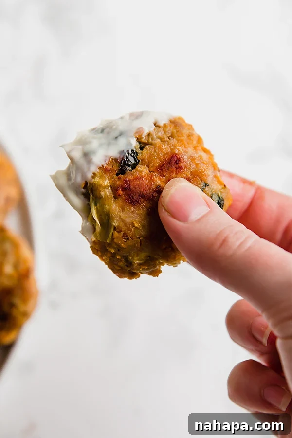 Creamy Spinach Artichoke Chicken Sweet Potato Bites 4 Closeup of cooked Spinach and Artichoke Sweet Potato Chicken Poppers on a serving platter