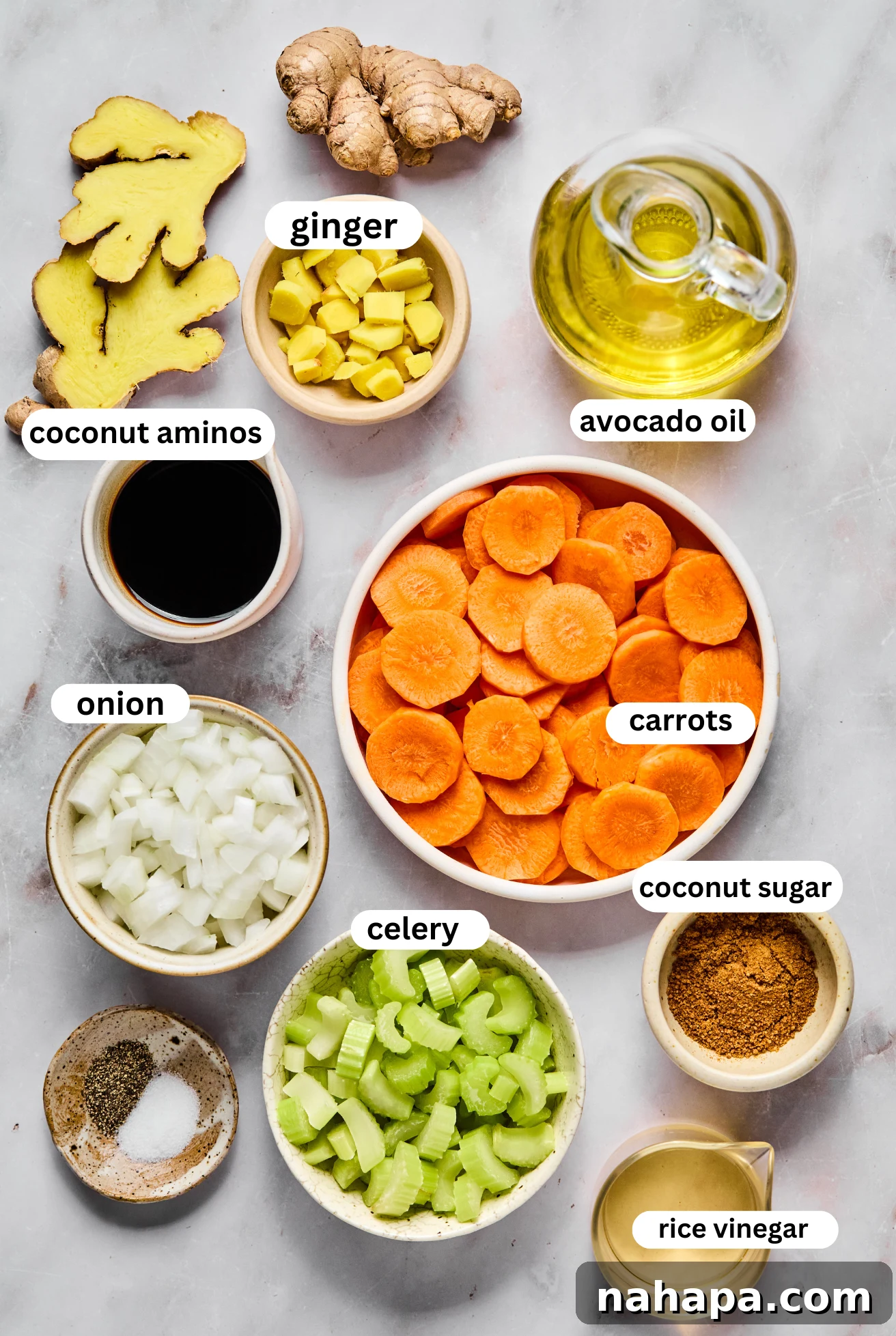 Hibachi Style Ginger Dressing 3 Individual bowls of fresh ingredients laid out for Japanese ginger dressing: chopped carrots, celery, yellow onion, fresh ginger, avocado oil, coconut aminos, and rice vinegar.