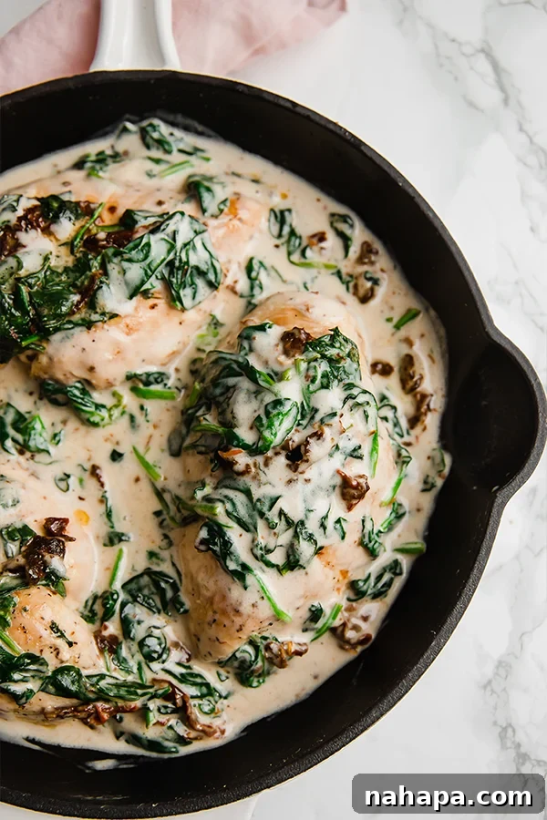 Creamy Tuscan Chicken Skillet 4 Tuscan Chicken Skillet presented beautifully in a cast iron pan, ready to be served, highlighting the vibrant colors and creamy texture.