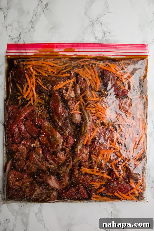 Freezer bag filled with ingredients for Slow Cooker Mongolian Beef, ready for meal prep.