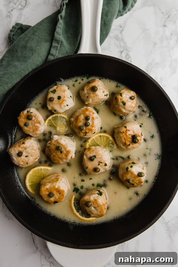 Lemon Caper Chicken Meatballs 3 chicken piccata meatballs in skillet