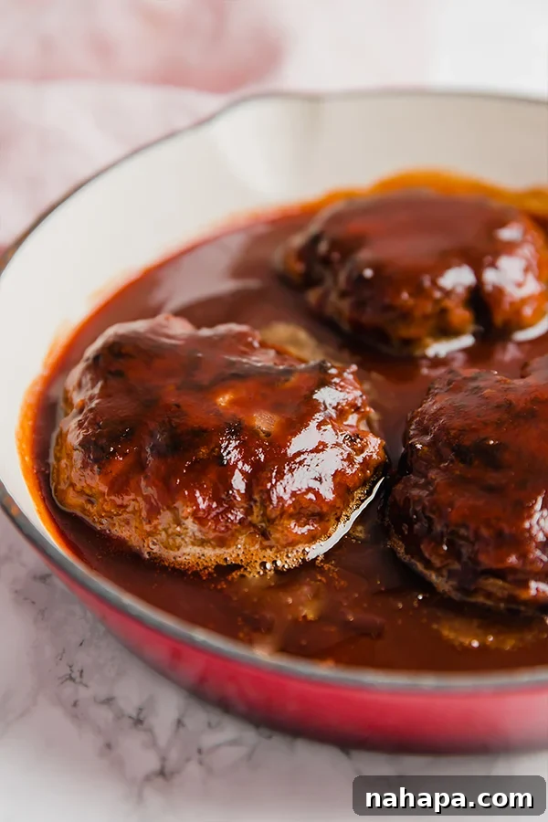 Close-up of a Japanese Hamburger Steak patty coated in glossy, savory sauce, ready to be served.