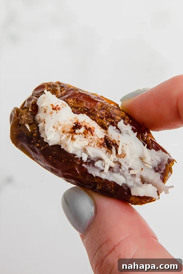 Irresistible Date Pairings 5 Stuffed dates filled with creamy coconut butter and topped with delicate toasted coconut flakes, arranged beautifully for a tropical snack.