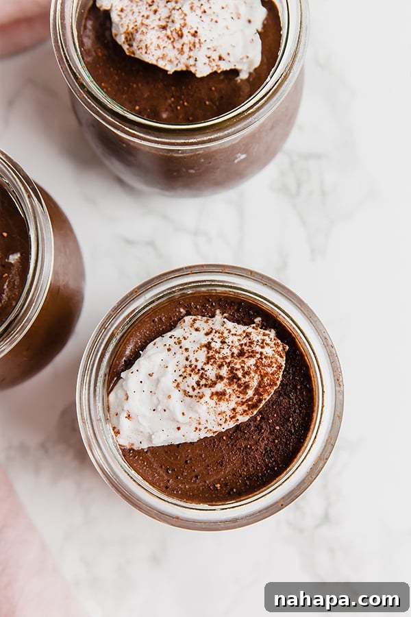 Homemade chocolate pudding in a bowl with a spoon.