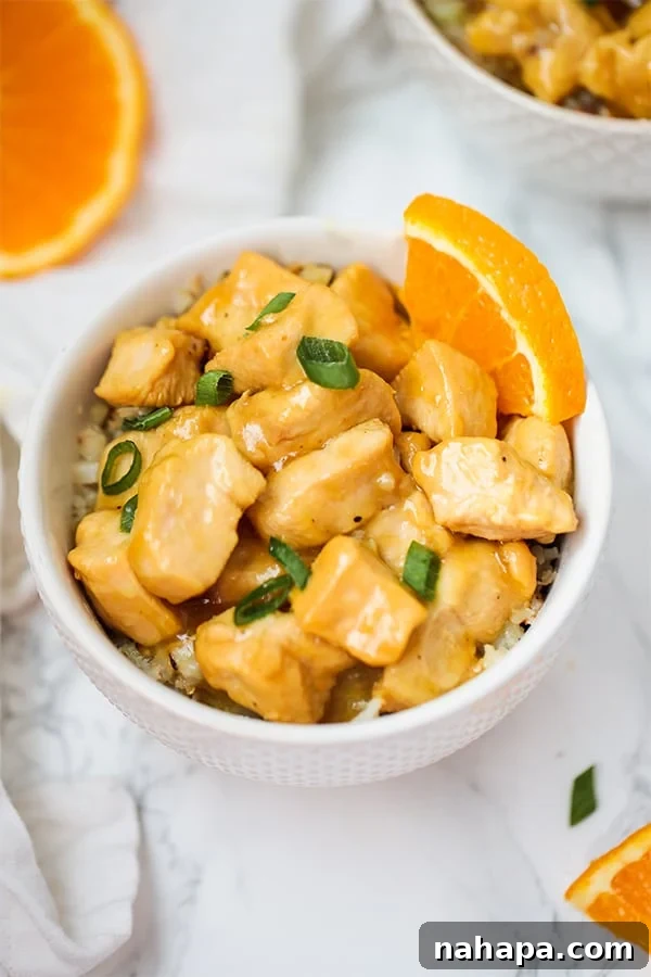 Slow Cooker Orange Chicken served with broccoli