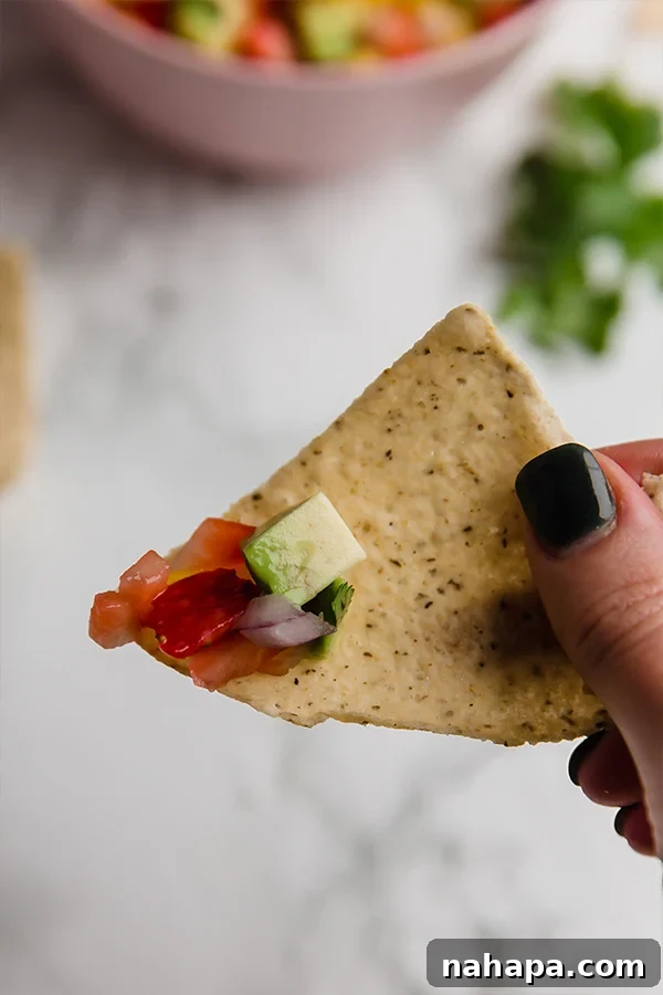 Scoop of strawberry mango salsa on a tortilla chip