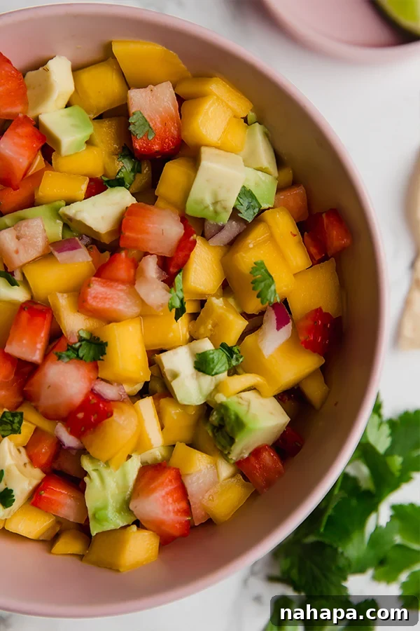 Close-up shot of a bowl of freshly made strawberry mango salsa