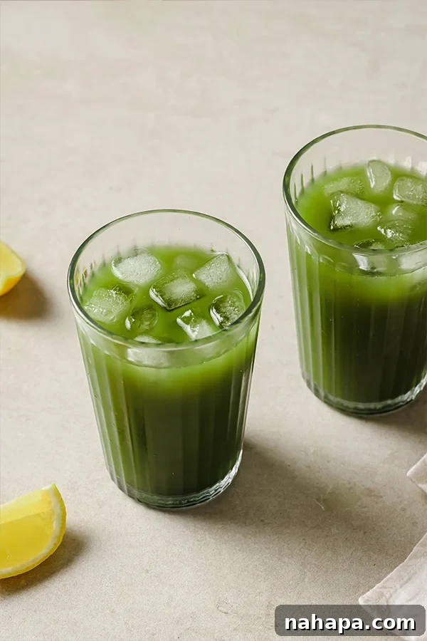 Vibrant Matcha Lemonade 2 Iced Matcha Lemonade in a glass with lemon slices