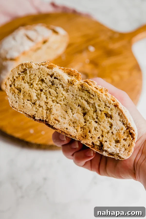 Unbaked gluten-free bread dough resting in a bowl, covered