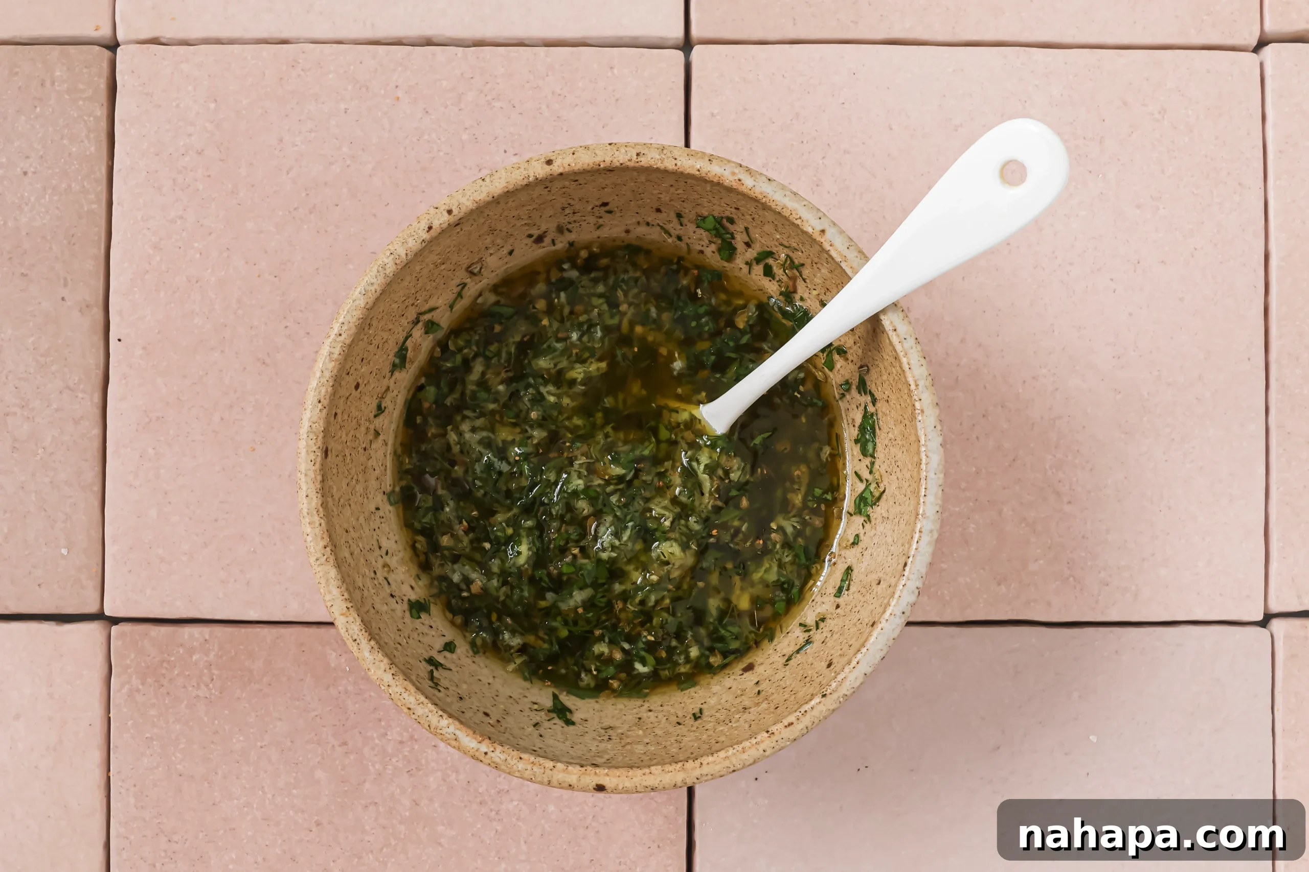 A bowl of fresh, vibrant chicken souvlaki marinade, a fragrant blend of olive oil, lemon juice, herbs, and spices.