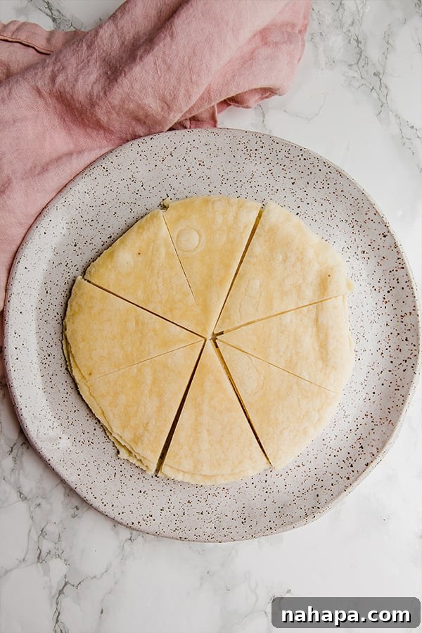 Almond flour tortillas being cut into wedges for cinnamon chips