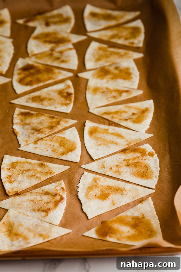 Brushing cinnamon sugar mixture onto grain-free tortilla chips