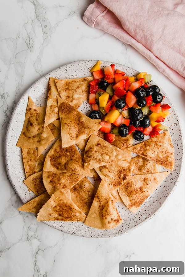 Close-up of crispy cinnamon sugar chips with fresh fruit salsa in a bowl