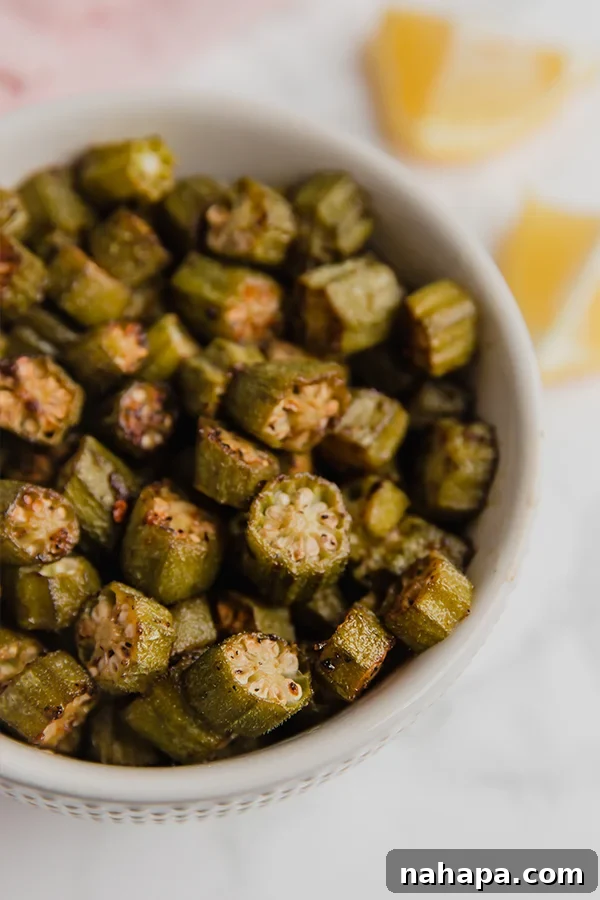 Crispy Oven Roasted Okra 4 Close-up of freshly oven-roasted okra slices in a bowl, showcasing their crispy texture.