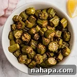 Crispy Oven Roasted Okra 5 A top-down view of a small bowl of oven-roasted okra, garnished and ready to serve.