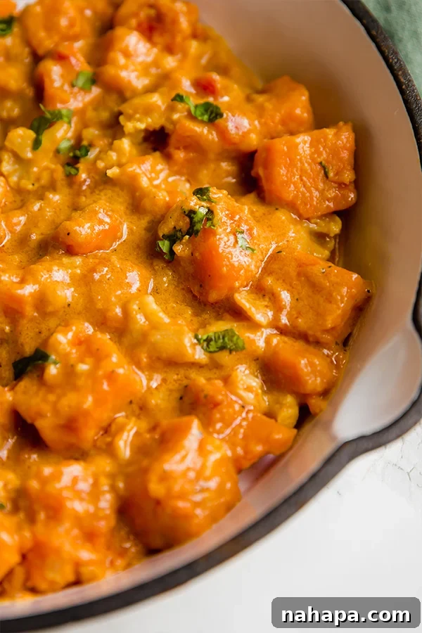 Vibrant Sweet Potato Cauliflower Curry Clean and Wholesome 3 Sweet potato cauliflower curry simmering in a pan, vibrant and delicious