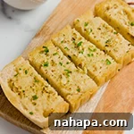 Top-down shot of a golden-brown gluten-free garlic bread with a single star rating