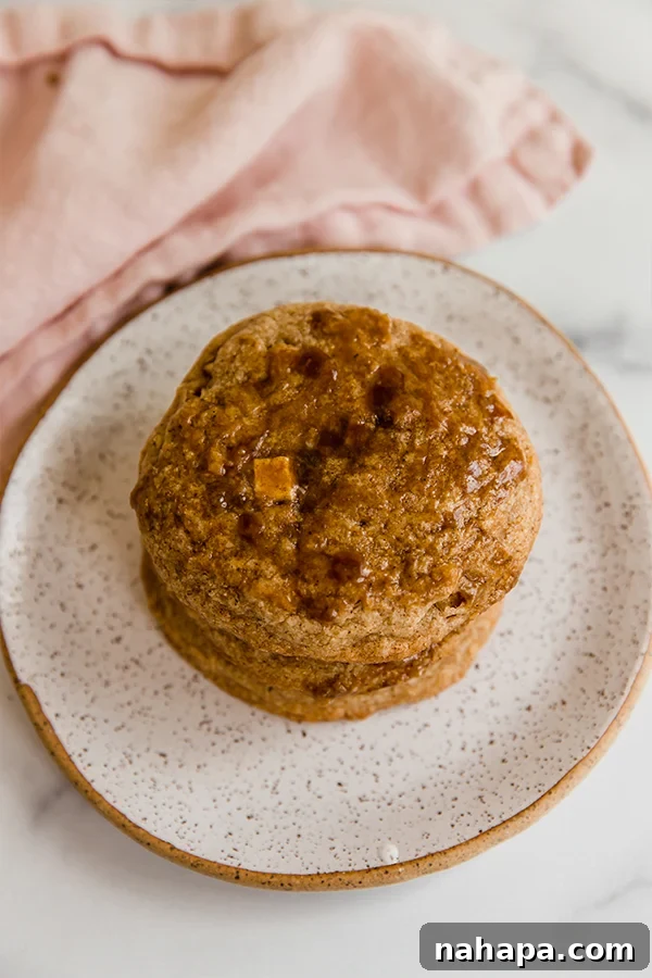 Close-up of baked caramel apple cookies on parchment paper