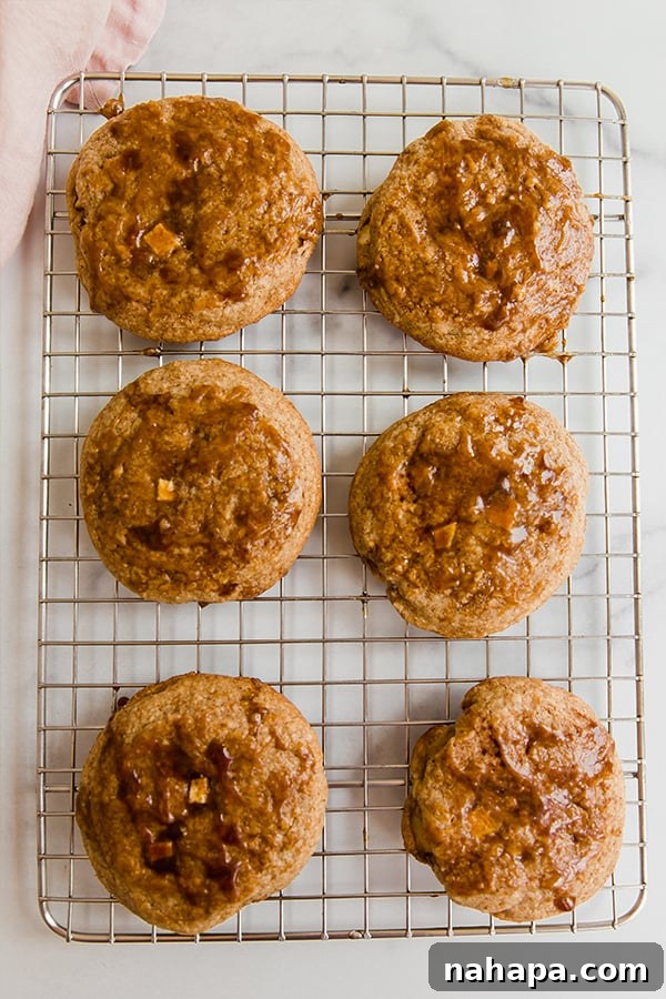 Stacked Caramel Apple Cookies on a cooling rack