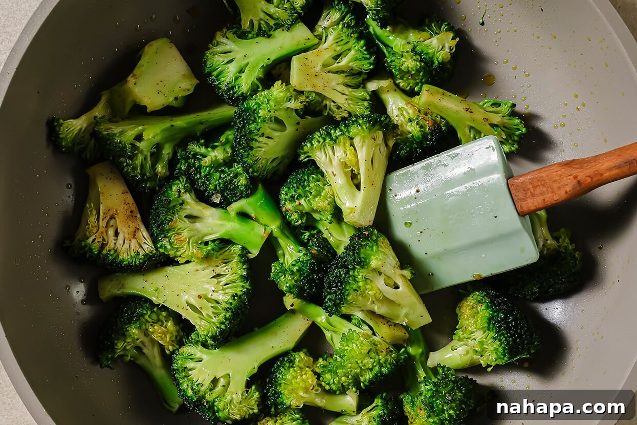 Hearty Ground Beef and Broccoli Skillet 5 Broccoli florets sautéing in a pan, displaying a vibrant green color.