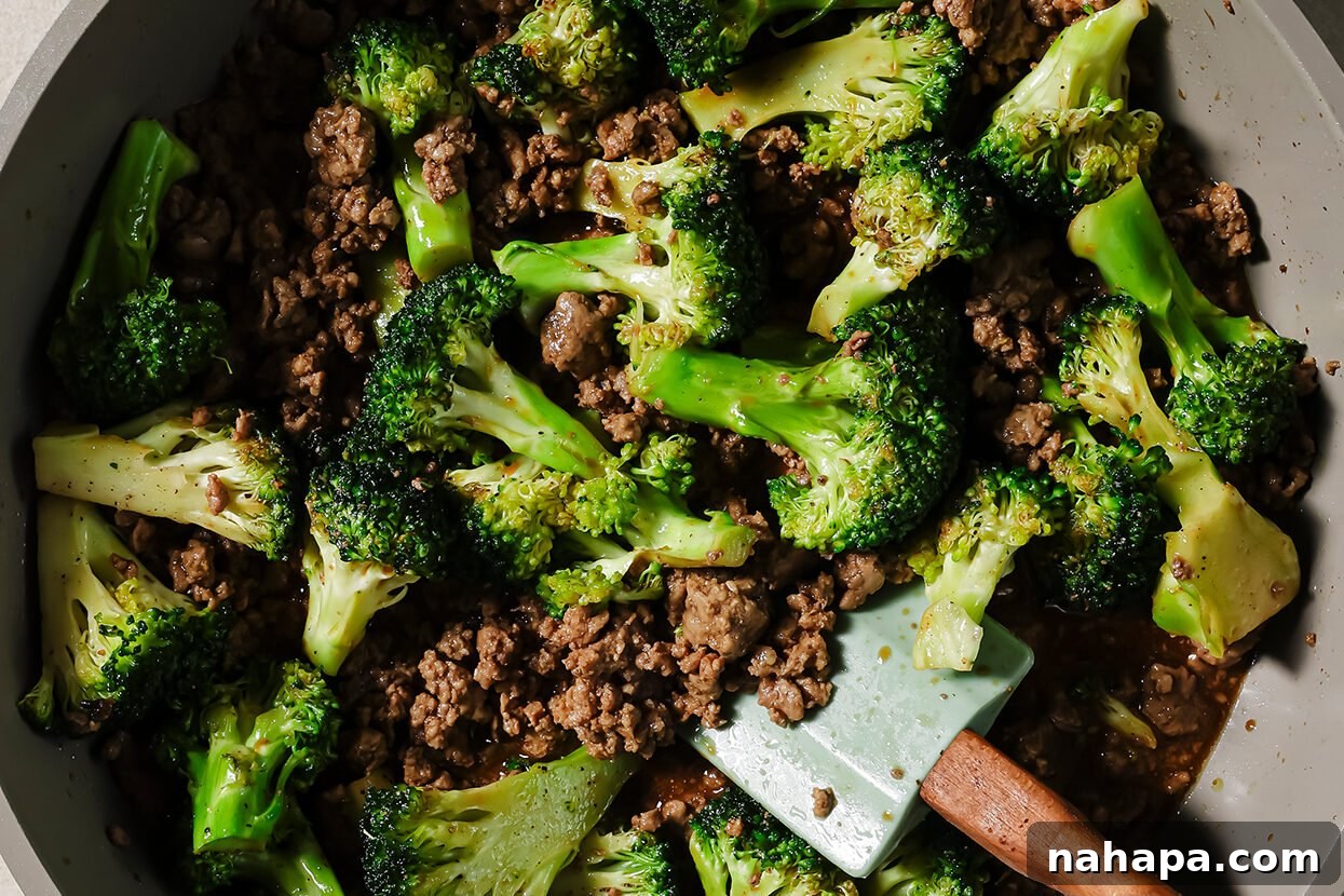 Hearty Ground Beef and Broccoli Skillet 6 Ground beef cooking and crumbling in a pan, showing its browning process.
