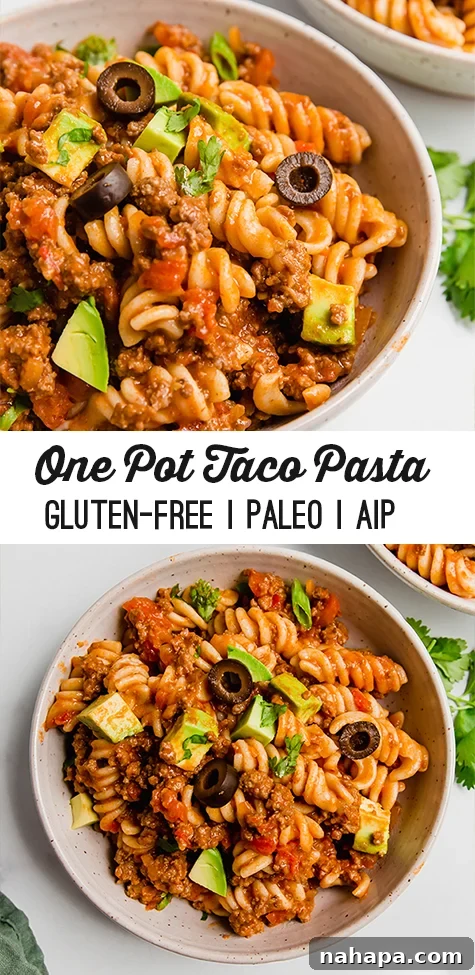 One-pot paleo taco pasta served in a bowl with fresh avocado and cilantro, alongside a fork. A vibrant, inviting meal.