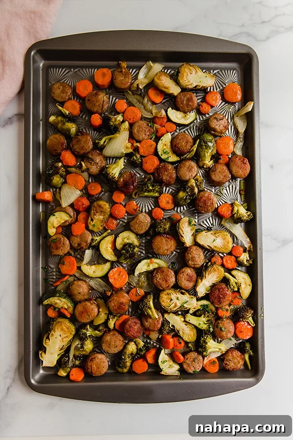 Effortless Sheet Pan Sausage and Veggies Paleo Whole30 Gluten Free 3 Close-up of roasted one-pan sausage and vegetables in a pan, showcasing caramelized edges.