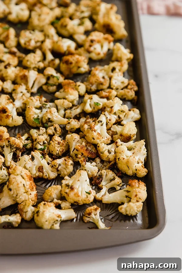 Ranch Roasted Cauliflower served on a baking sheet, garnished with fresh herbs.
