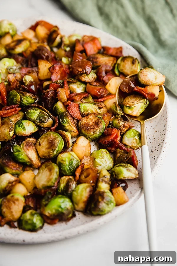 Bacon Date Apple Brussels Sprout Skillet on a plate with a serving spoon