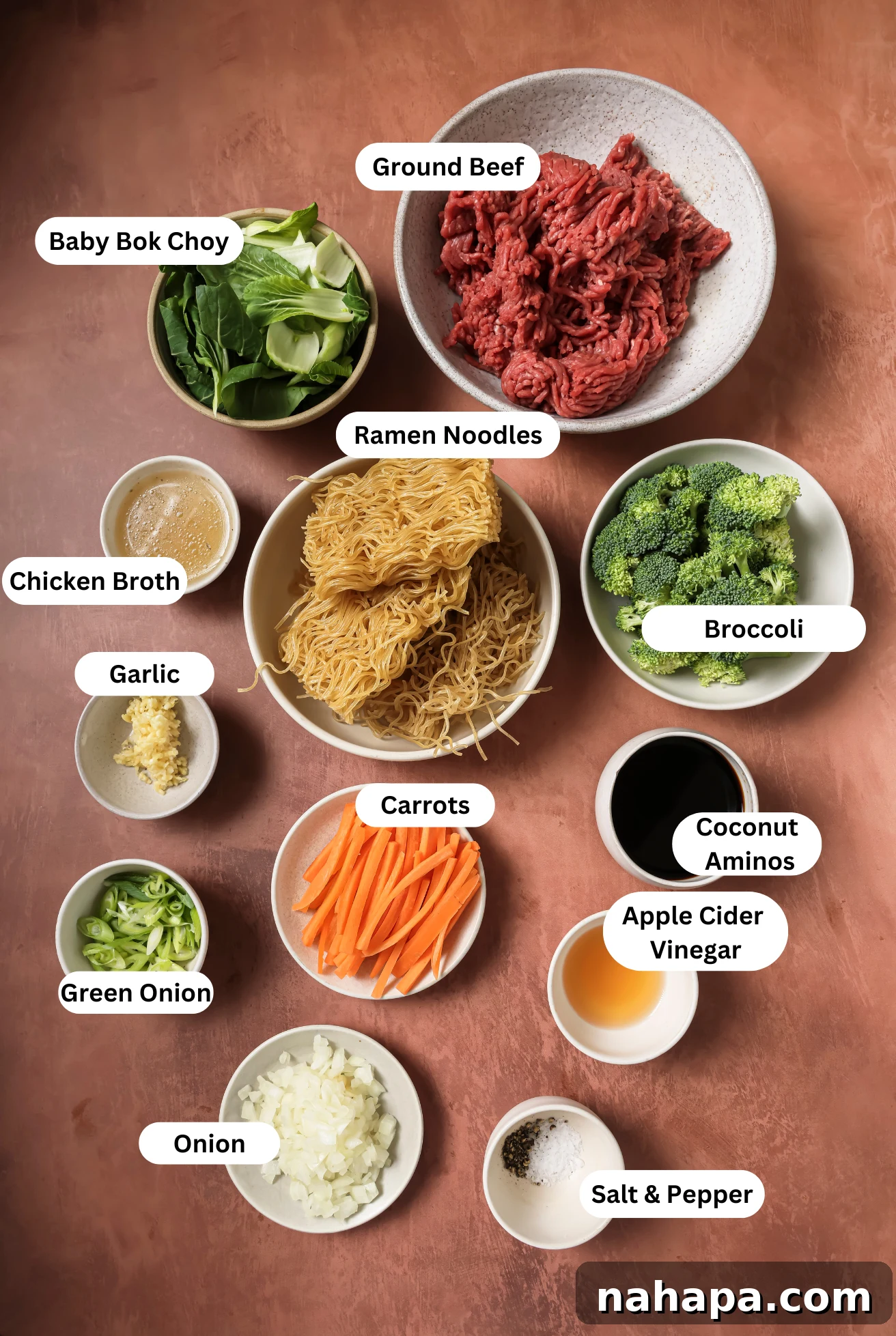 All the fresh and carefully measured ingredients laid out for making the healthy ground beef ramen noodle stir fry, including beef, a variety of colorful vegetables, and gluten-free ramen noodles.
