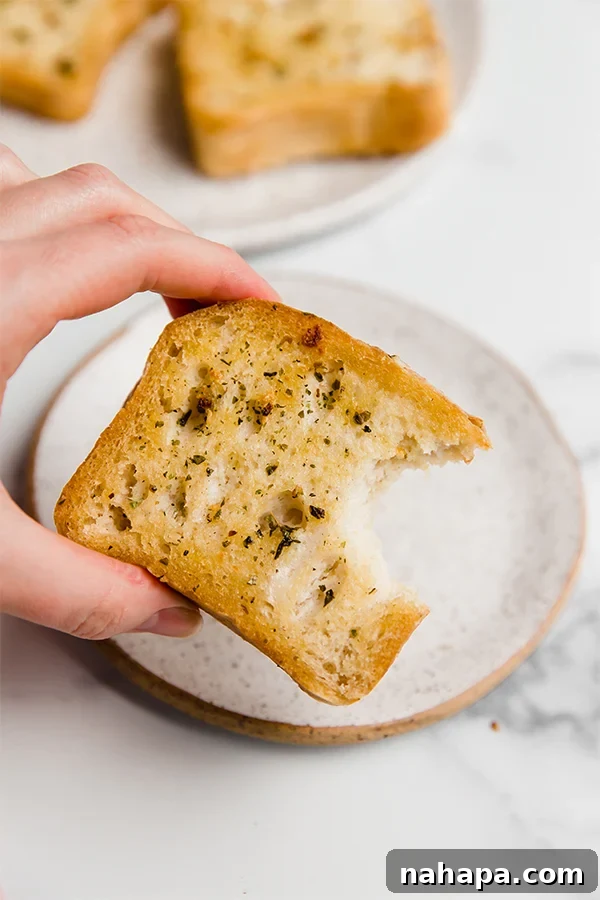 Garlic Butter Gluten-Free Texas Toast 4 Gluten-free Texas Toast served on a plate with fresh parsley garnish