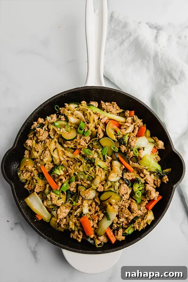 Ground Turkey and Vegetable Teriyaki Stir Fry in a cast iron skillet, ready to be served.