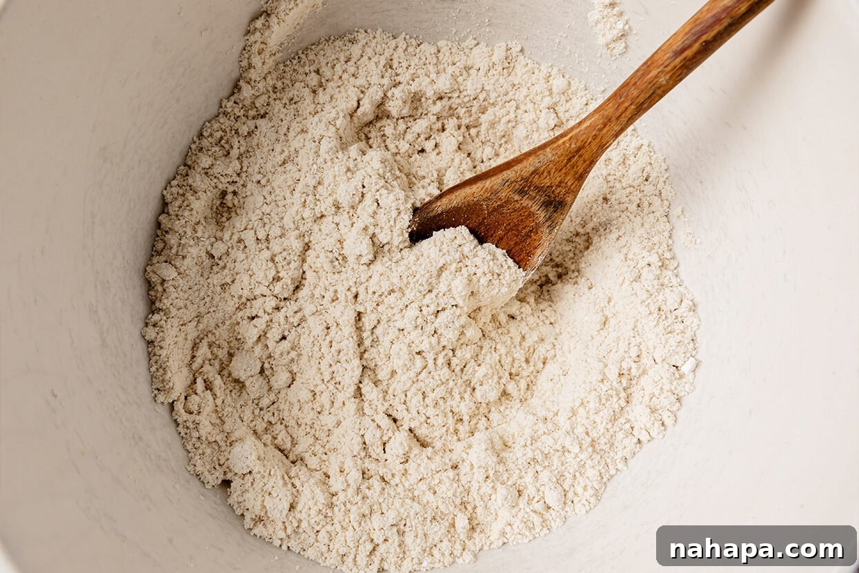 A bowl containing the dry ingredients for Snickerdoodle cookies, meticulously sifted and ready for the wet ingredients.