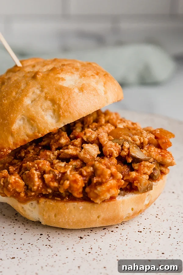 Wholesome Turkey Sloppy Joe Paleo AIP Whole30 3 Turkey sloppy joe served in a sandwich bun with a toothpick, ready for a delicious meal.