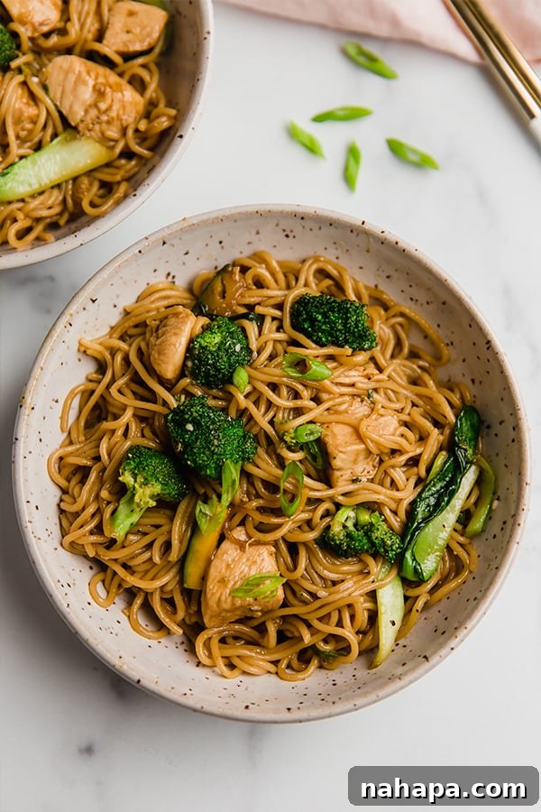 A full bowl of chicken and ramen stir fry, ready to be enjoyed, showing the vibrant colors of the ingredients.