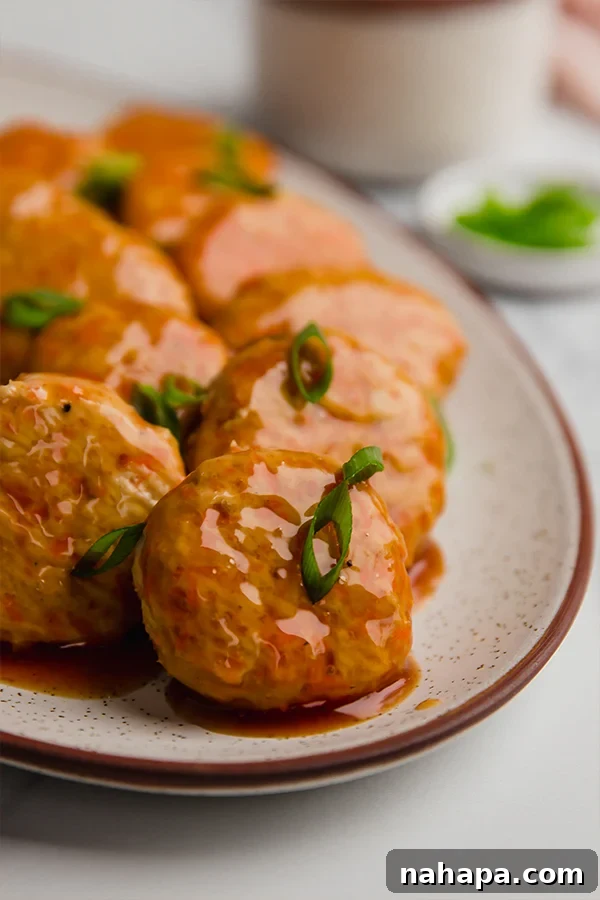 Guilt-Free Sweet and Sour Chicken Poppers 5 Plated sweet and sour chicken poppers, garnished with green onions, ready to be enjoyed.