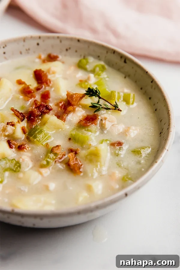 A full bowl of dairy-free paleo clam chowder, ready to be enjoyed, with a focus on its comforting appeal.
