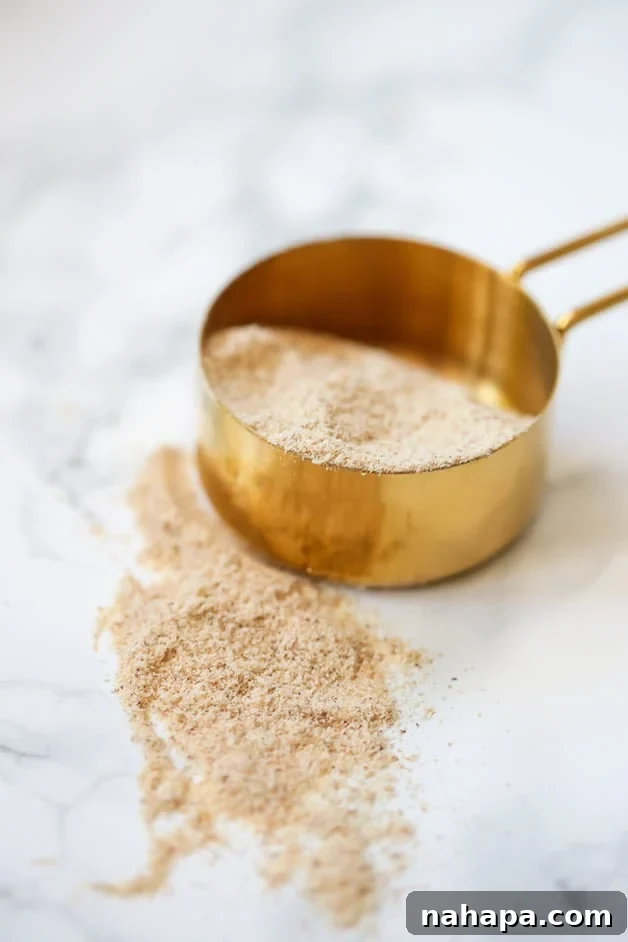 Tigernut flour being measured in a cup, highlighting a key ingredient