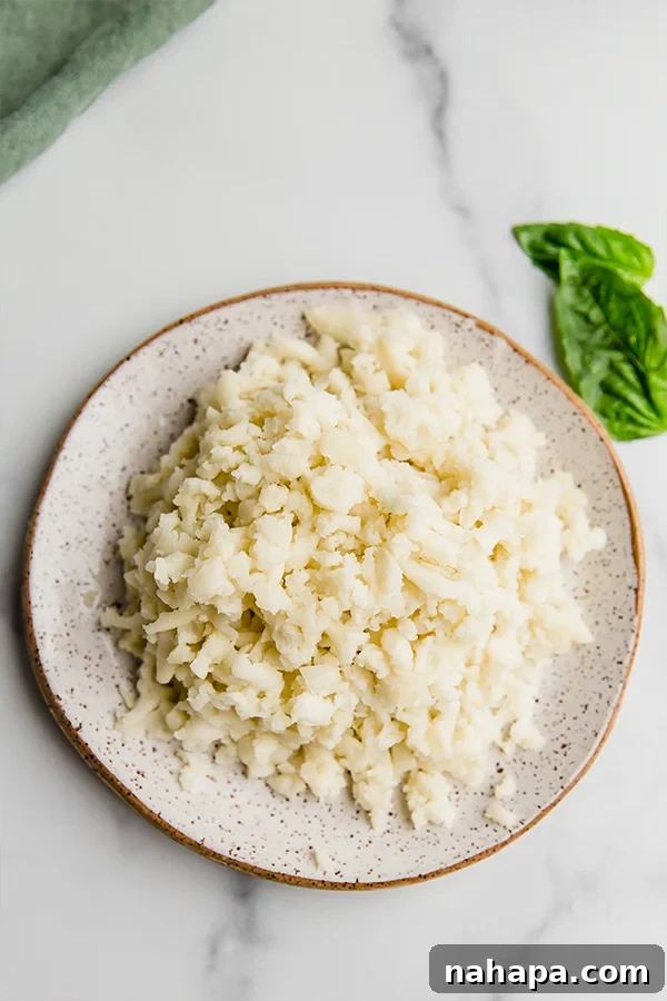 Shredded AIP mozzarella cheese on a plate, ready for serving